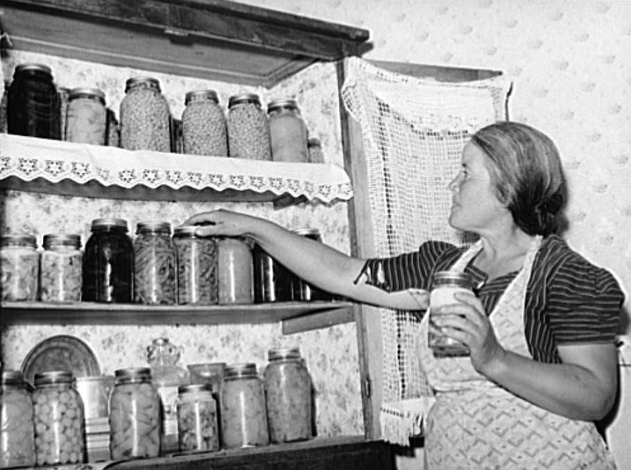 Farmer's wife with canned fruit and vegetables, Camisal, New Mexico Photo: Russell Lee