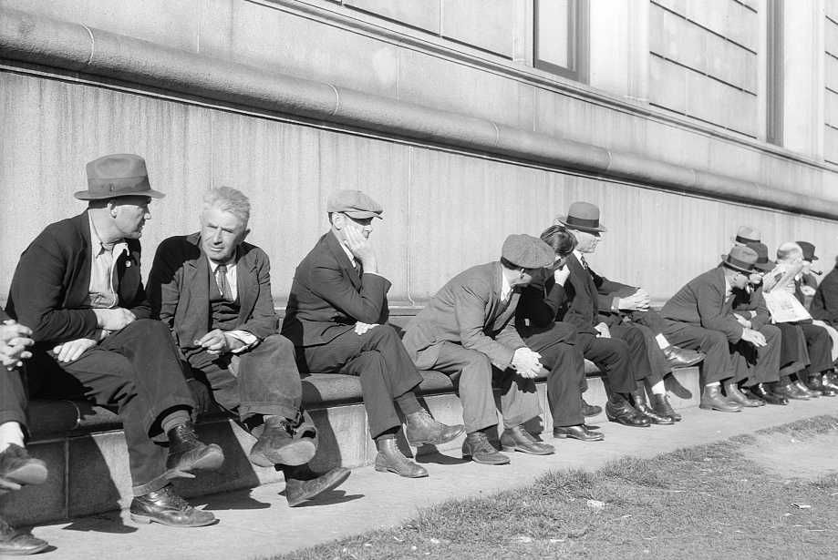 Unemployed men sitting on the sunny side of the San Francisco Public Library. California       Photo: Dorothea Lange