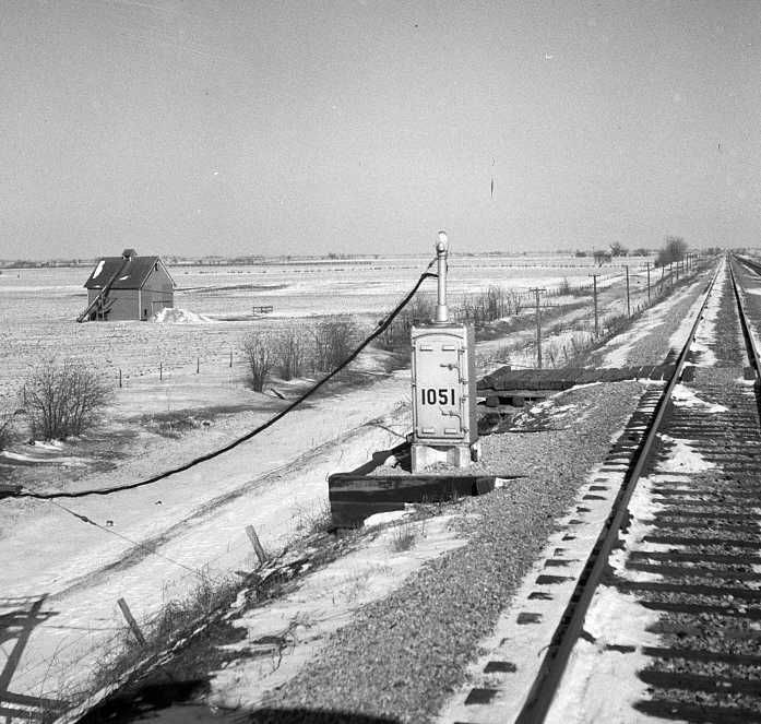 The track between Pequot, Illinois and Fort Madison, Iowa.  1051 stands for the first relay box in the 105th mile from Chicago      Photo: Jack Delano