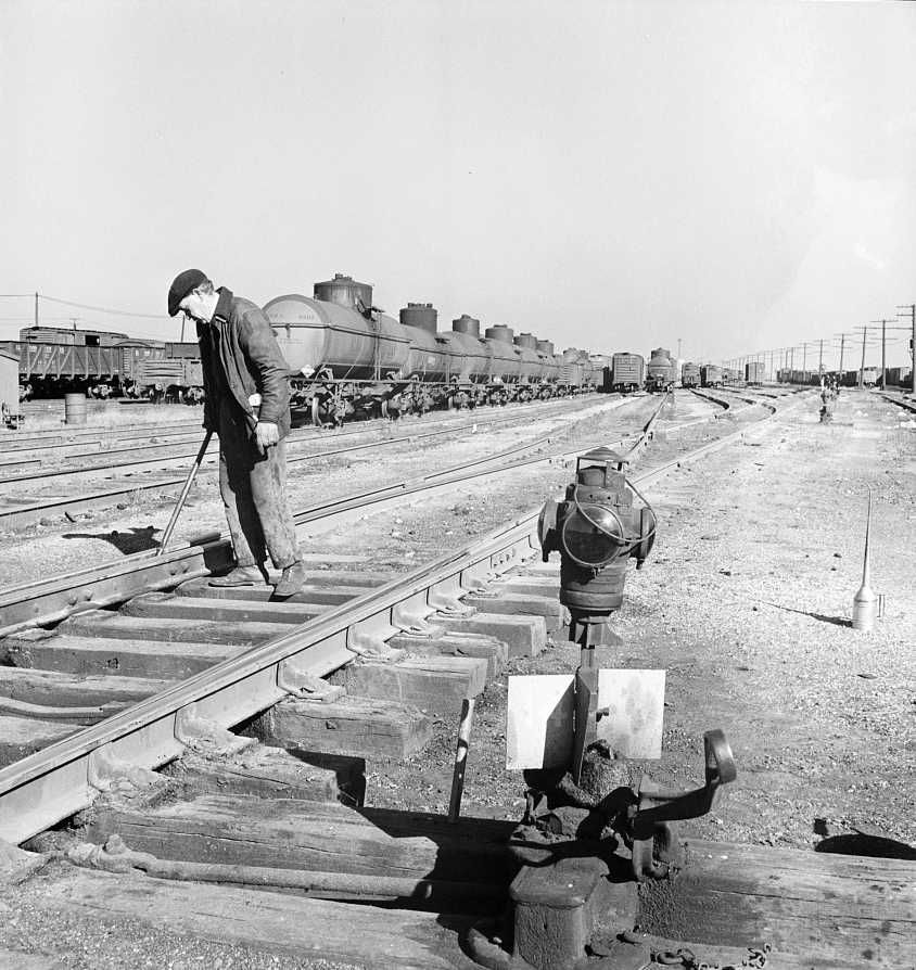 One of the yard gang cleaning out switches at an Illinois Central Railroad yard - Photo: Jack Delano