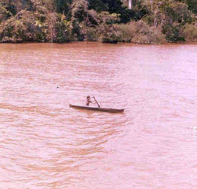 Rain-forest canoe with young traveler