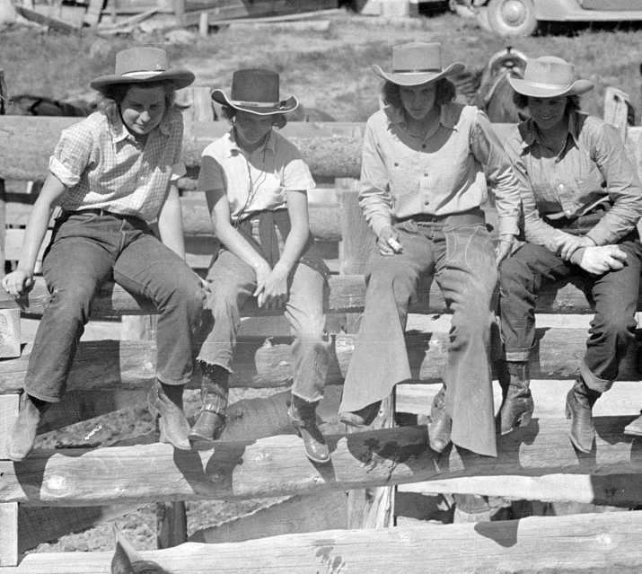 Dude girls on a corral fence, Quarter Circle U roundup, Montana   Photo: Arthur Rothstein