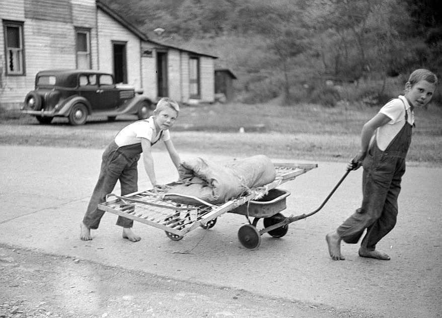 Children taking home remains of a bed. Coal mining camp, Scotts Run, West Virginia Photo: Marion Post Wolcott