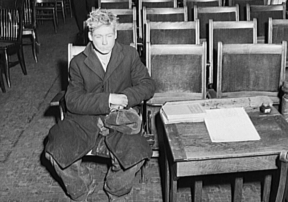 Young boy waiting to see if he can get a place to sleep for the night in city mission. Dubuque, Iowa Photo:  John Vachon