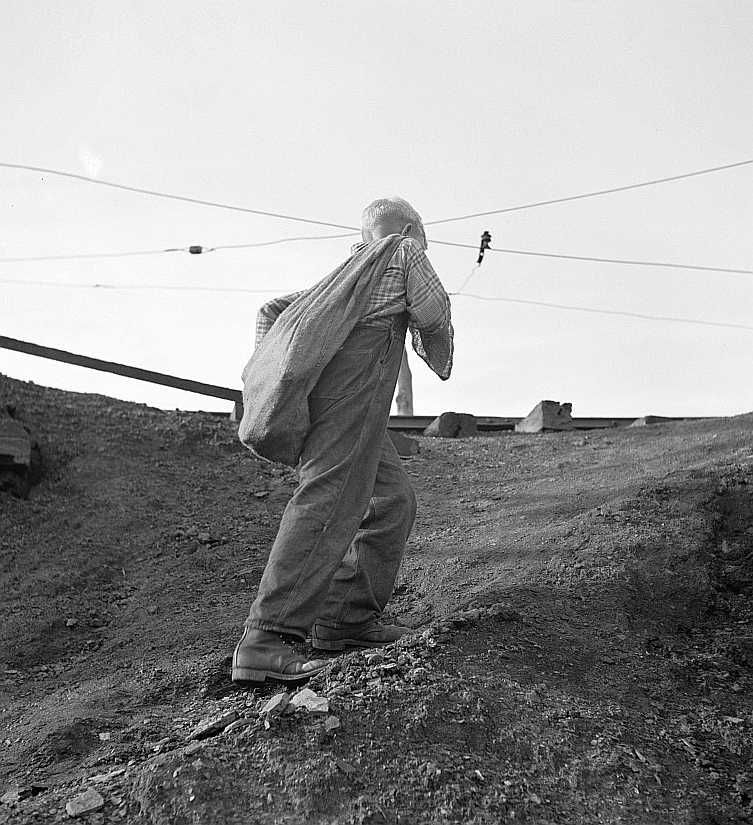 Coal miner's son carrying home bag of coal swiped from cars.  The 