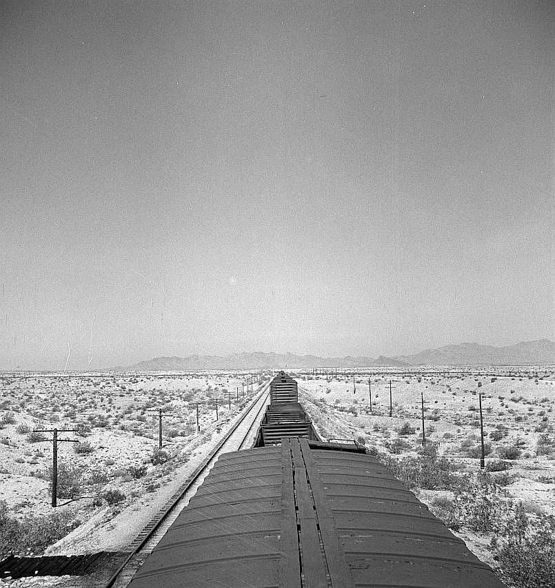 The Atchison, Topeka, and Santa Fe Railroad train between Needles and Barstow, California cuts west across the Mojave Desert  Photo: Jack Delano