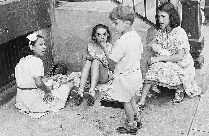 New York, New York. 61st Street between 1st and 3rd Avenues. Children playing in the street    Photo: Walker Evans