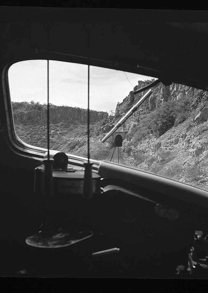 Williams (vicinity), Arizona. A train on the Atchison, Topeka, and Santa Fe Railroad between Winslow and Seligman, Arizona about to enter a tunnel through a hillside Photo: Jack Delano