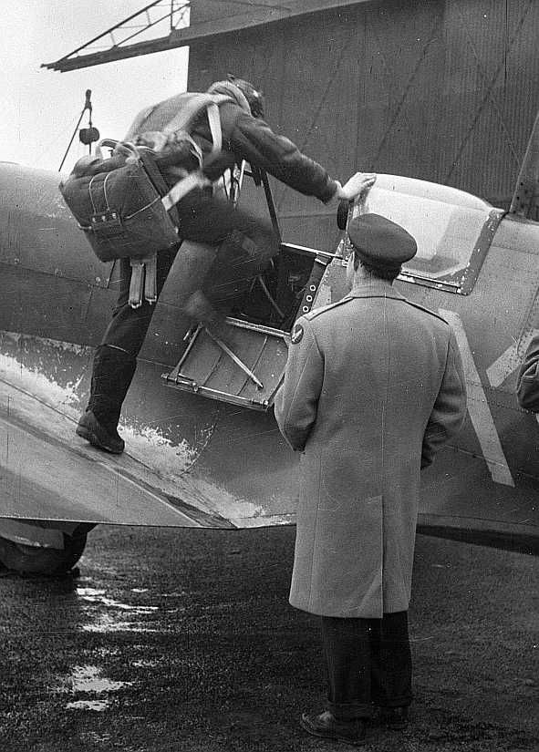 Lieutenant E.S. Schofield, of Belleville, Ohio and Lieutenant R.F. Sargent of Youngstown, Ohio, pictured in Britain, as the former prepares to pilot a Spitfire plane.