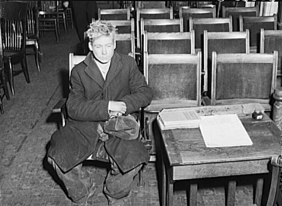 Young boy waiting to see if he can get a place to sleep for the night. City mission, Dubuque, Iowa - John Vachon FSA/Library of Congress