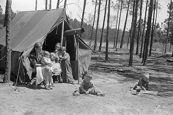 Home of one of two families who travel and work together all through the South, repairing stalls, stoves, tools, houses, and any other odd jobs. Tourist camp near Atlanta, Georgia  Photo: Marion Post Wolcott